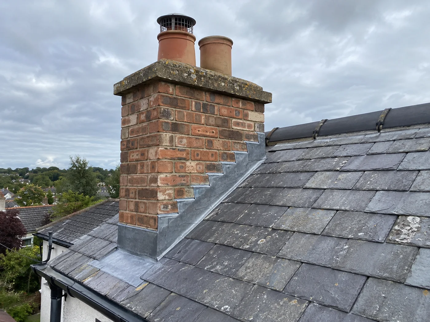 Brick chimney with pots and stepped lead flashing